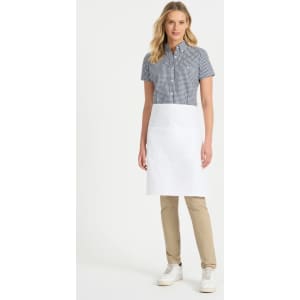 A ladies' short sleeve button-up shirt in a black and white check pattern, paired with a white apron and beige pants.