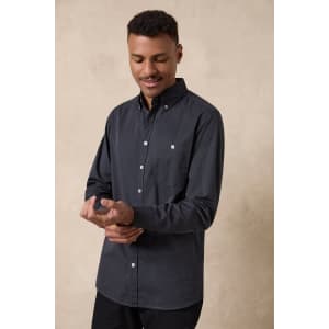 A men's long sleeve button-up shirt in dark grey, featuring a single chest pocket and a branding logo.