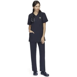 A unisex scrub top in navy blue, featuring a V-neck and pocket, worn with matching navy pants and a stethoscope.