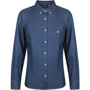 A ladies long sleeve button-up shirt in dark denim blue with a chest pocket and a branded label.