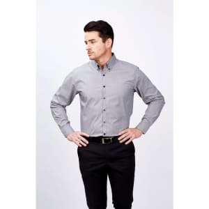 A long-sleeve grey button-up shirt with a collar, featuring a logo, worn by a man standing with hands on hips.