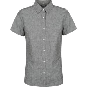 A grey short sleeve shirt with a button-up front and a collar. It features a logo on the label.