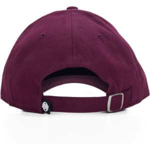 A burgundy cap featuring a rear strap adjustment and a logo on the side.