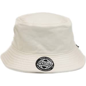 A cream bucket hat featuring a round logo on the front. It has a wide brim and a structured design.