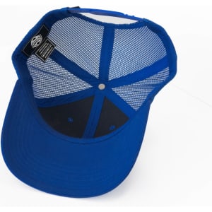 A blue trucker cap with a mesh interior and a black lining on the underside of the brim. It has a logo tag inside.