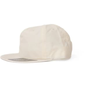 A cream-coloured cap with a rounded brim and a logo on the front.