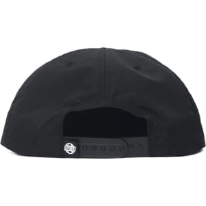 A cap in black, featuring a structured back and circular logo on the strap.