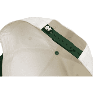 A two-tone cap featuring a cream interior and a green exterior, equipped with an adjustable snap closure.