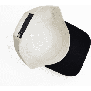 A two-tone cap featuring a cream-coloured top and a black brim. The cap has an internal logo and adjustable strap.