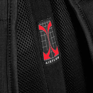 A close-up of a breathable black fabric with a red logo labelled "AIRFLOW" on a backpack.