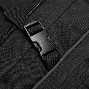 A close-up of a black backpack featuring a sturdy buckle and textured fabric. The design includes a zippered compartment.