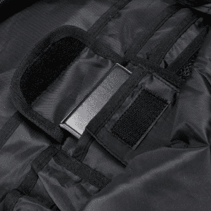 A close-up of a black backpack interior with fabric straps and a metal attachment point.