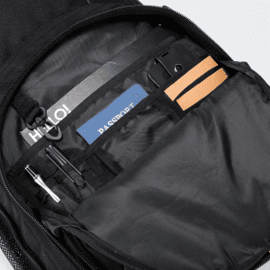 A black backpack interior featuring compartments for a passport, notepad, pens, and a phone. It includes a logo.