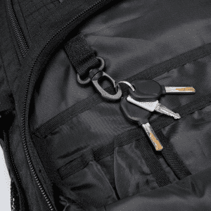 A black backpack interior featuring a keychain with several keys attached.