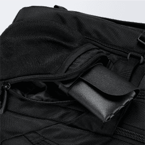 A black backpack featuring multiple zippered compartments, with one compartment containing a rolled-up item.