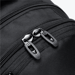 A close-up of a black backpack zipper, featuring dual zipper pulls and textured fabric.