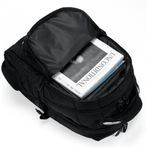 A black Eiger backpack with multiple compartments, featuring an open top revealing magazines inside.