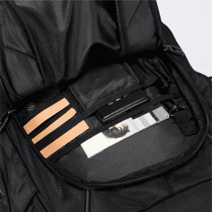 A black Eiger backpack interior featuring mesh pockets, elastic bands, and a few items including a photo and a card.