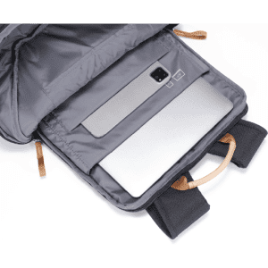 A grey backpack interior with a laptop compartment and tan handles. The bag features one logo on the exterior.