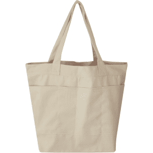 A beige tote bag featuring three exterior pockets and two sturdy handles. It has a simple, unbranded design.