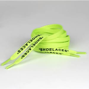 Bright green shoelaces with printed text and coated tips, coiled neatly against a plain background.
