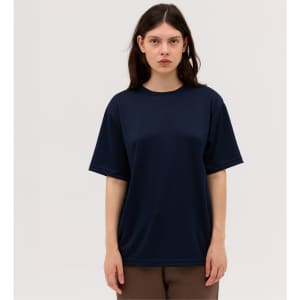 A navy blue T-shirt with a loose fit, featuring short sleeves and a round neckline, displayed on a model.