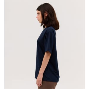 A navy blue short-sleeved tee featuring a loose fit and a branding logo.