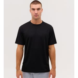 A black t-shirt displayed on a model, featuring a simple design and short sleeves. It has a logo on the front.
