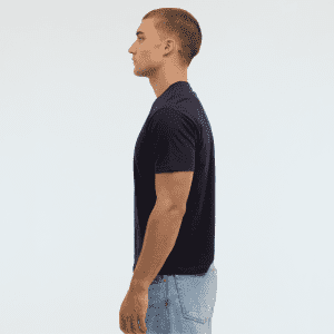 A navy blue Essential/Surf Tee displayed on a model in profile, showcasing its fit and design.