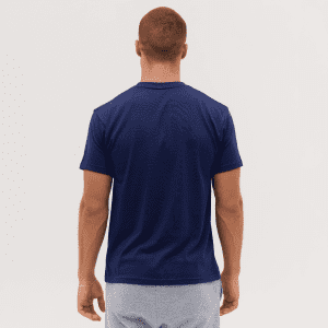 A navy blue T-shirt is displayed, featuring a plain back view and a fitted design. The model has short, brown hair.