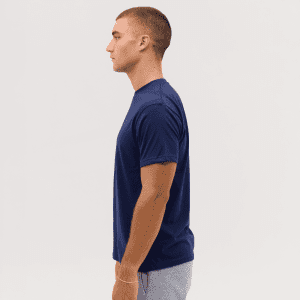 A navy blue T-shirt displayed on a model from the side, featuring a branding logo.