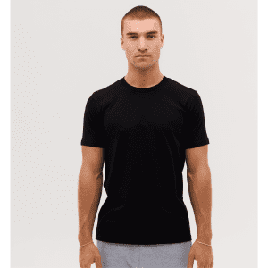 A plain black classic tee displayed on a model with short sleeves and a crew neck.