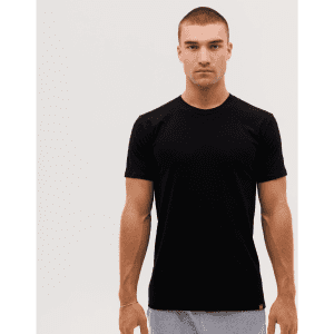 A black T-shirt displayed on a male model against a plain background, featuring a logo on the hem.