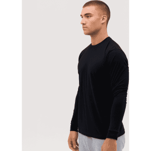 A black long sleeve tee displayed on a model, featuring a simple design and fitted silhouette.