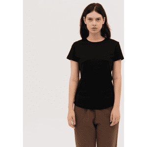 A black women's essential tee with a classic fit, paired with brown pants. The design features a logo on the shirt.