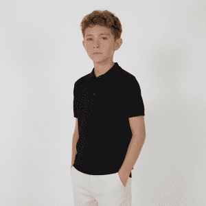 A youth's black polo shirt with a collar and buttons, featuring short sleeves. It has a logo on it.