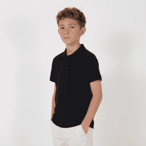 A black youth polo shirt displayed on a young model against a white background.