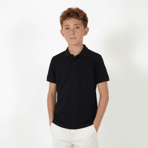 A youth polo shirt in black, featuring a collar and short sleeves, displayed on a model against a plain background.