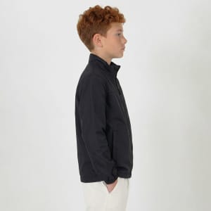 A youth jacket in black, featuring a collar and zip, displayed on a model from the side.