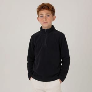 A young boy wearing a black polar fleece 1/4 zip jumper, standing against a plain background.