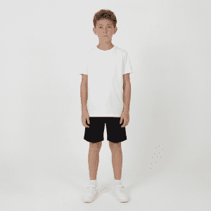 Youth Core Shorts in black, worn by a boy in a plain white t-shirt and white sneakers, standing against a plain background.