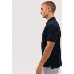 A navy polo shirt displayed on a model, featuring a classic collar and side slits for ease of movement.