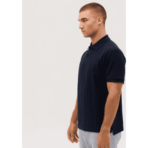 A navy polo shirt featuring a collar and short sleeves, displayed on a model from the side. The shirt has a logo.