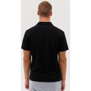 A black polo shirt with a simple design, viewed from the back, featuring short sleeves and a collar.