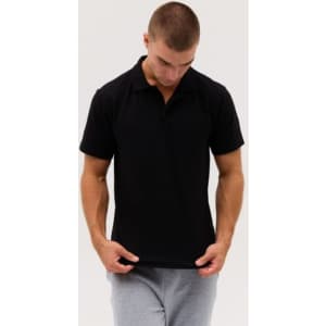 A black polo shirt is displayed, featuring a classic collar and short sleeves. The model wears grey sweatpants.