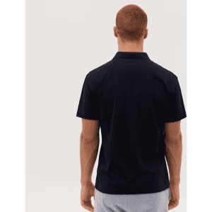 A man wearing a dark navy polo shirt, displayed from the back, with a simple design and a logo on the collar.