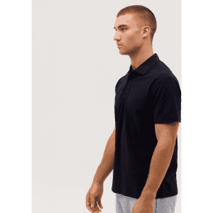 A navy polo shirt with short sleeves displayed on a model, featuring a collar and a logo on the chest.