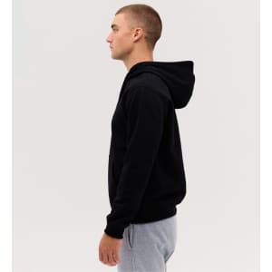 A black hooded sweatshirt displayed on a model, featuring a hood and a simple design.