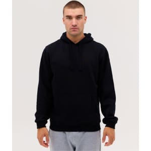 A man wearing a black hoodie with a front pocket, paired with grey sweatpants. The hoodie has a drawstring hood.