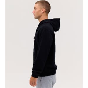 A black hoodie on a male model, featuring a front pocket and a hood, set against a plain background.